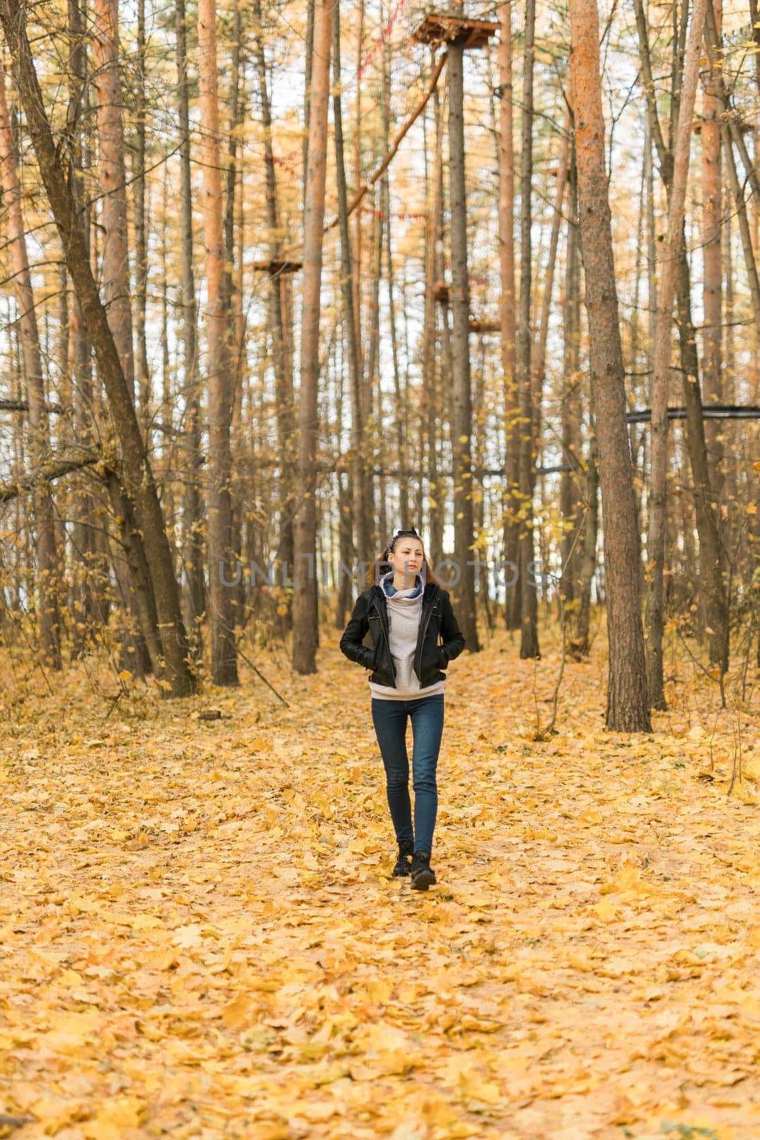 Outdoor atmospheric lifestyle portrait of young beautiful young woman copy space. Warm autumn fall season. Millennial generation and youth.