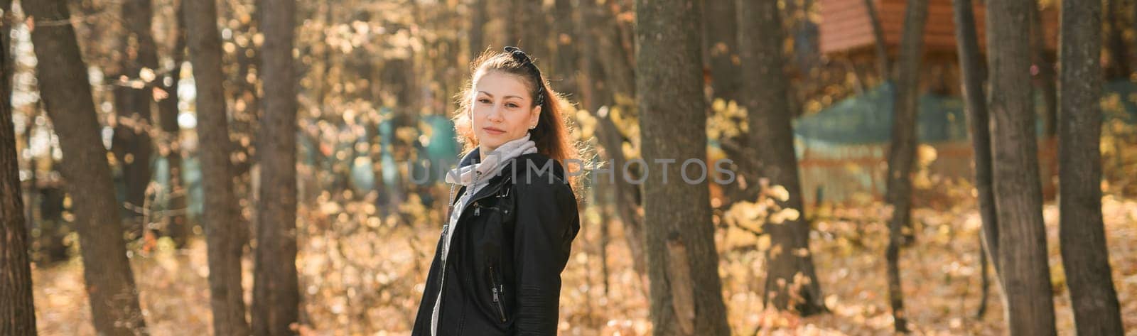 Outdoor atmospheric lifestyle portrait of young beautiful young woman copy space. Warm autumn fall season. Millennial generation and youth.