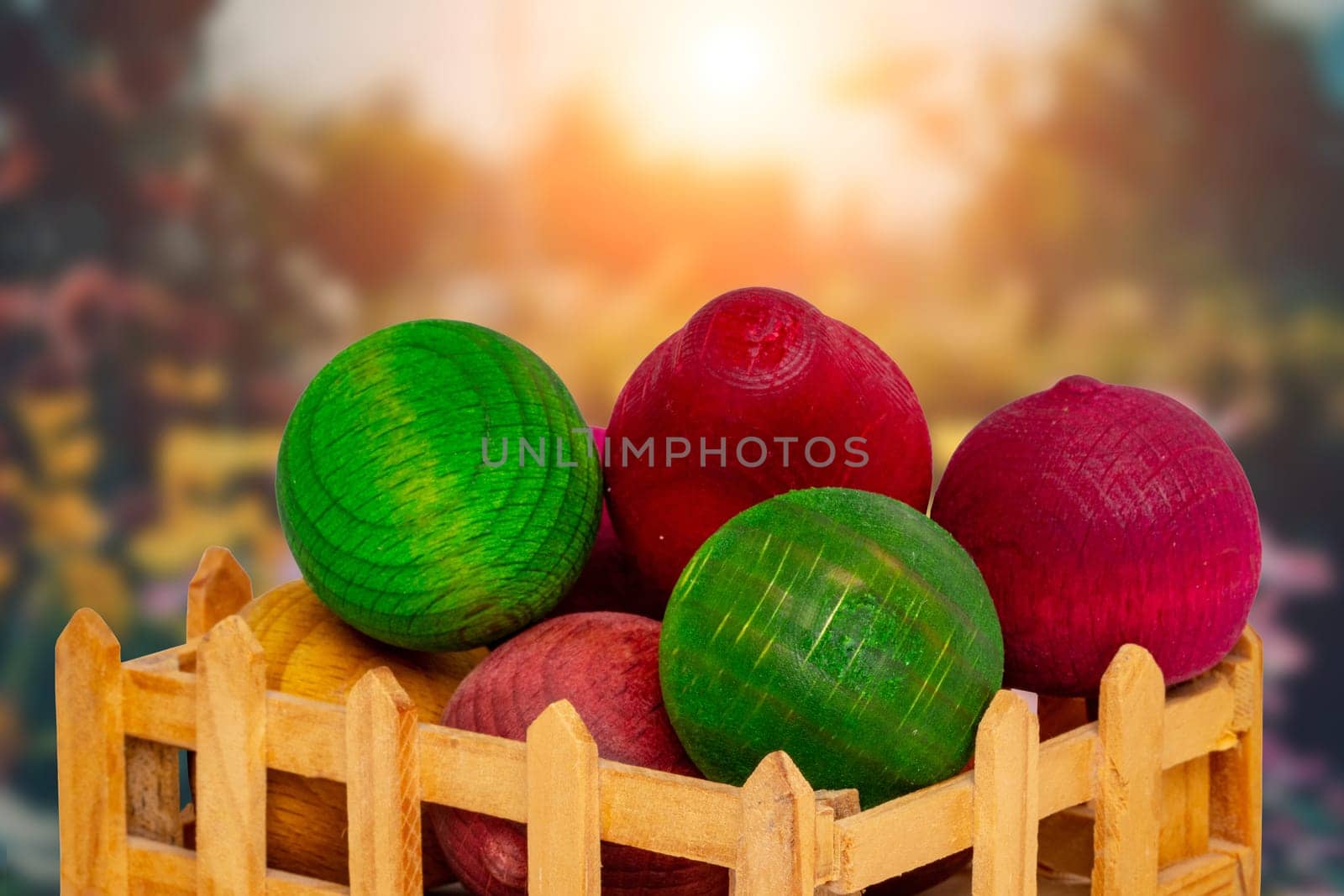 Air freshener. A small wooden box with various wooden balls scented with essential oils in front of a blurred abstract forest.  Fresh aroma just like in a natural forest. Nice gift.