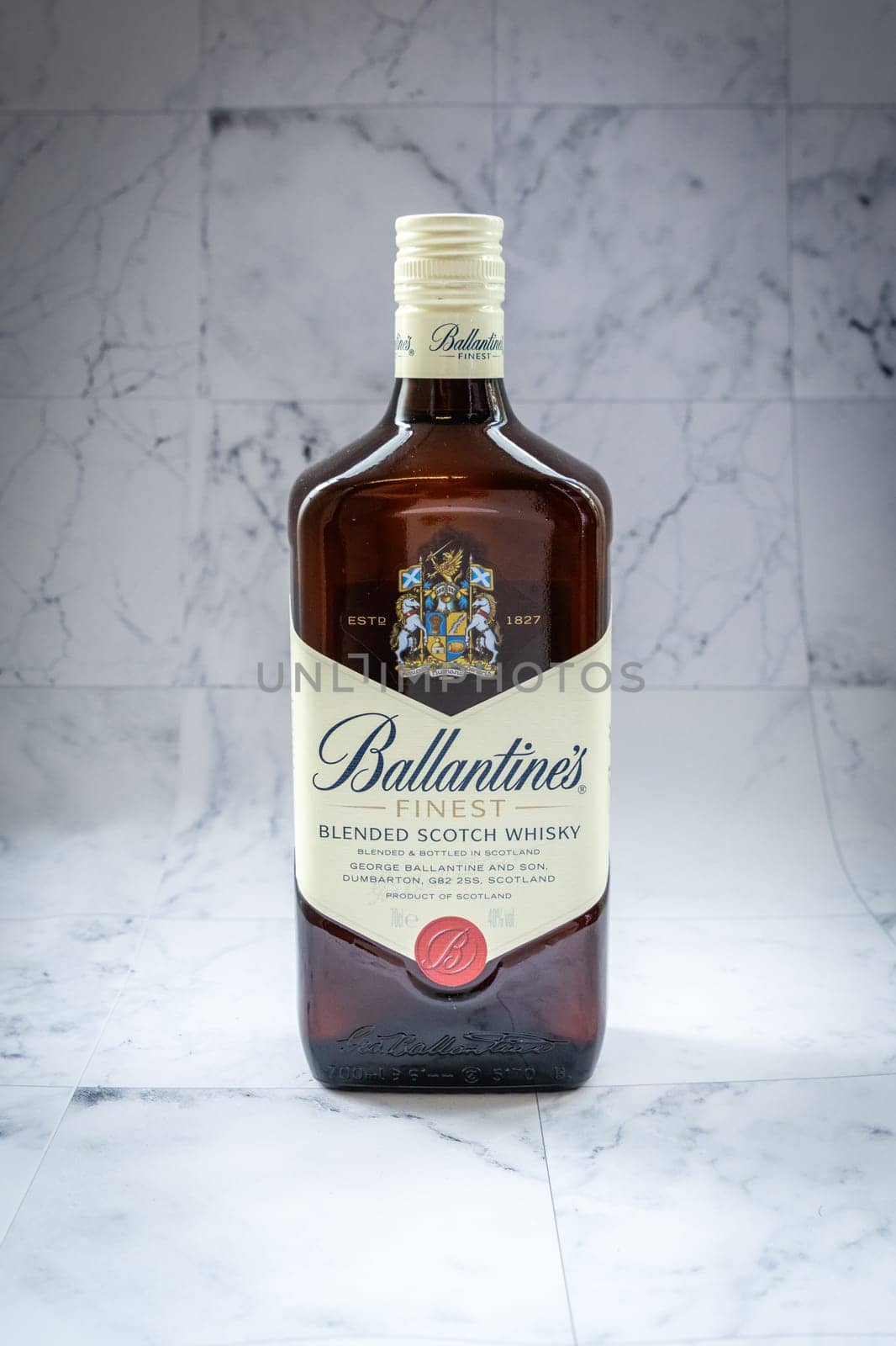 Lyon, FRANCE - JUNE 7, 2023: Ballantines whisky on gradient background. Ballantines is blended scotch whisky produced produced by Pernod Ricard in Dumbarton, Scotland.