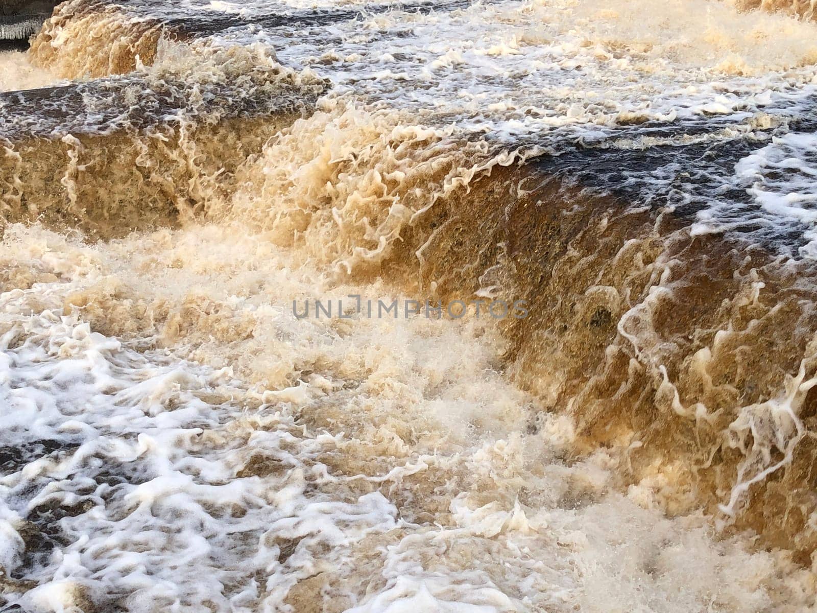 waterfall, the stream of water breaks into billions of splashes, seethes and foams, view from above