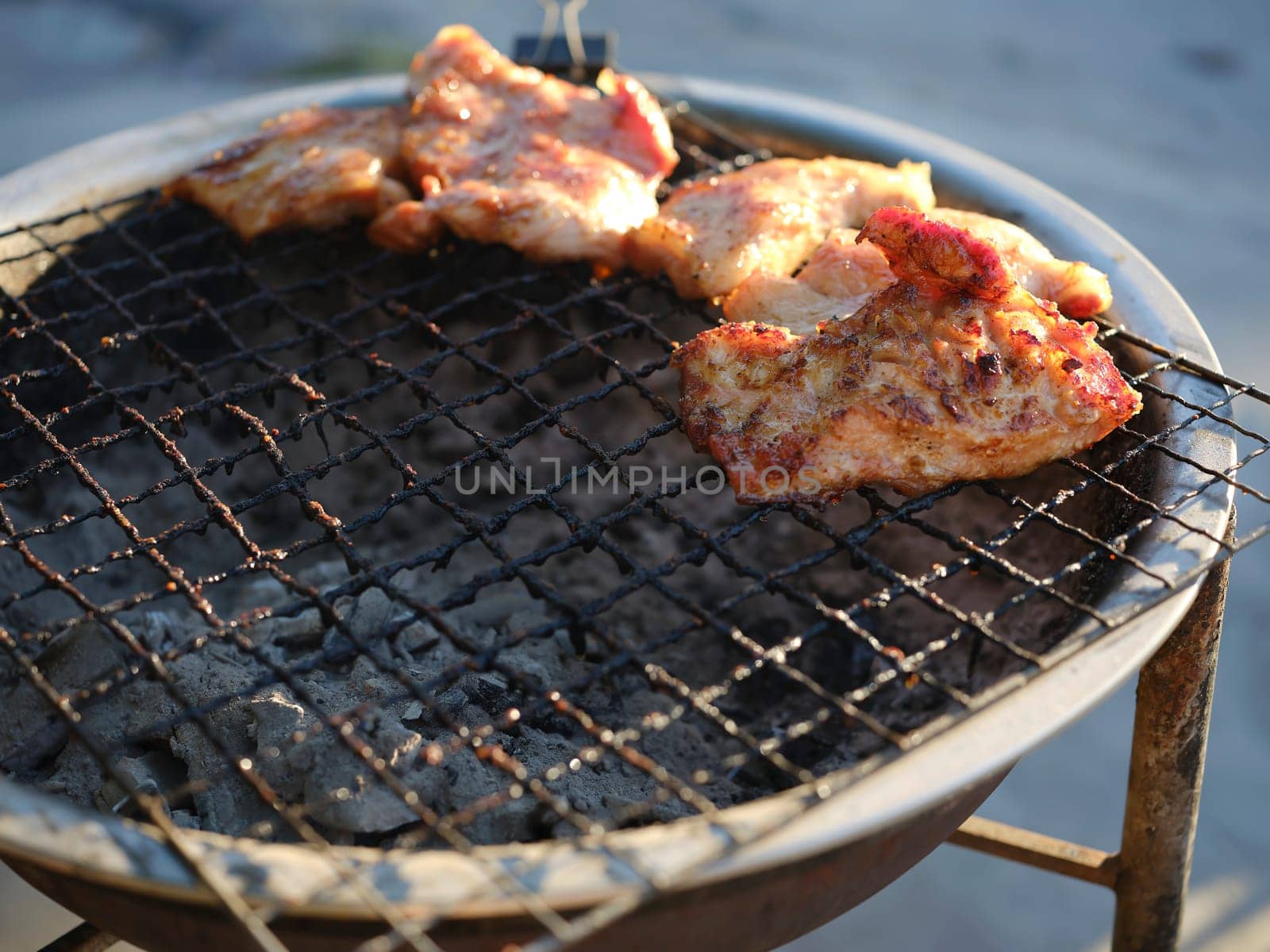 Thai street Food , Pork neck grilled  on the grill .