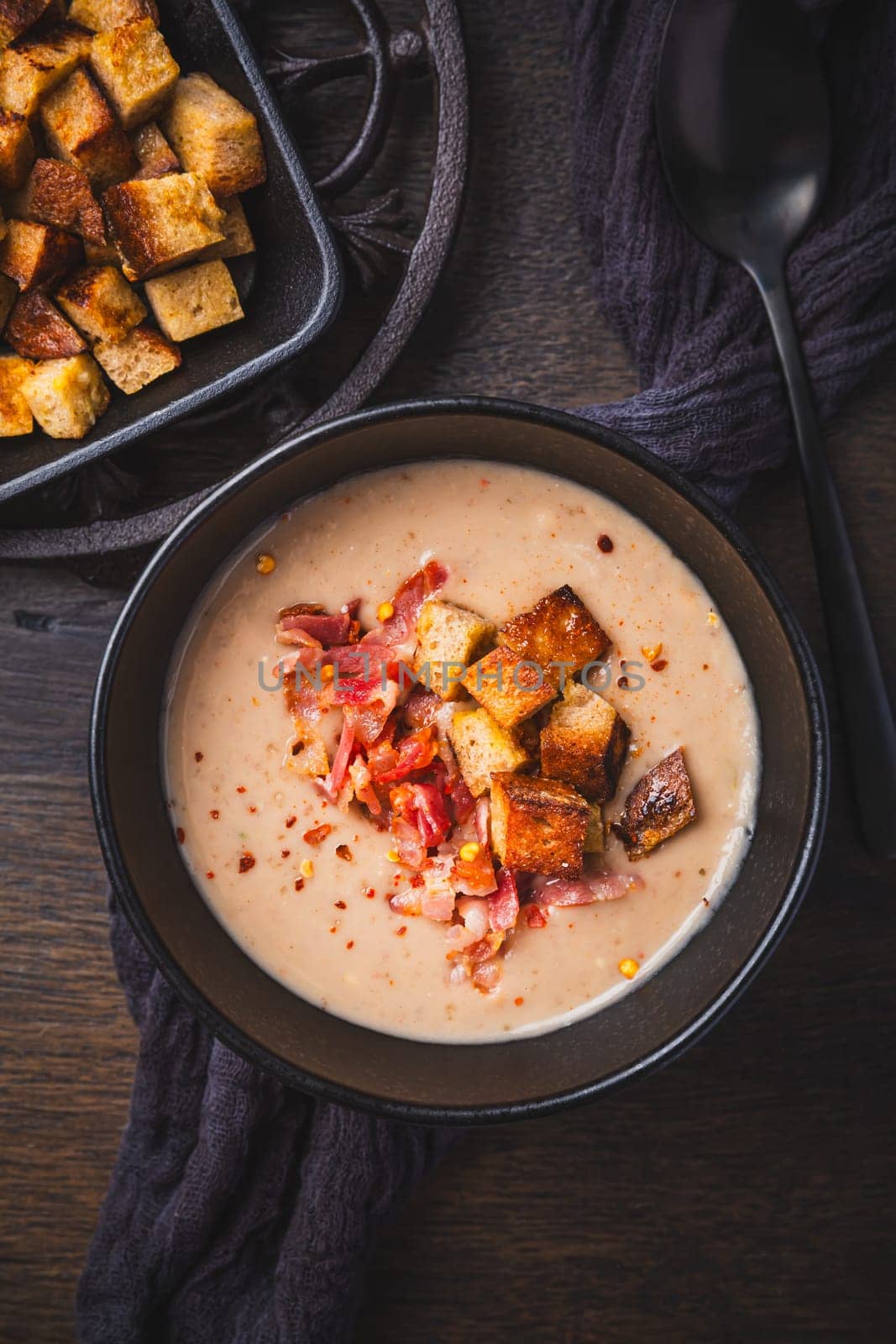 Homemade sweet chestnut soup with bacon and bread croutons