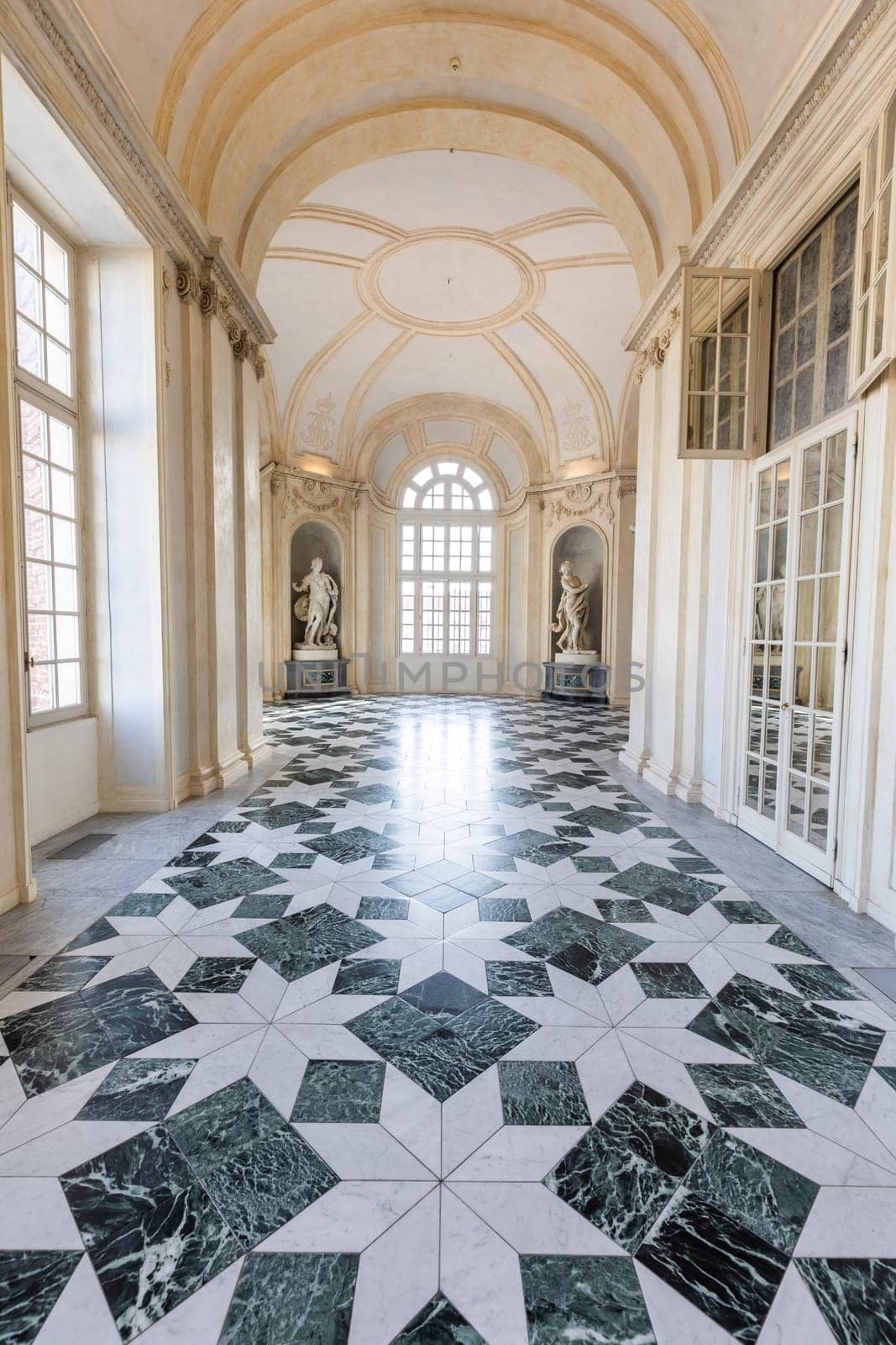 Venaria Reale, Italy - January 2023: luxury interior old royal palace. Gallery perspective with window