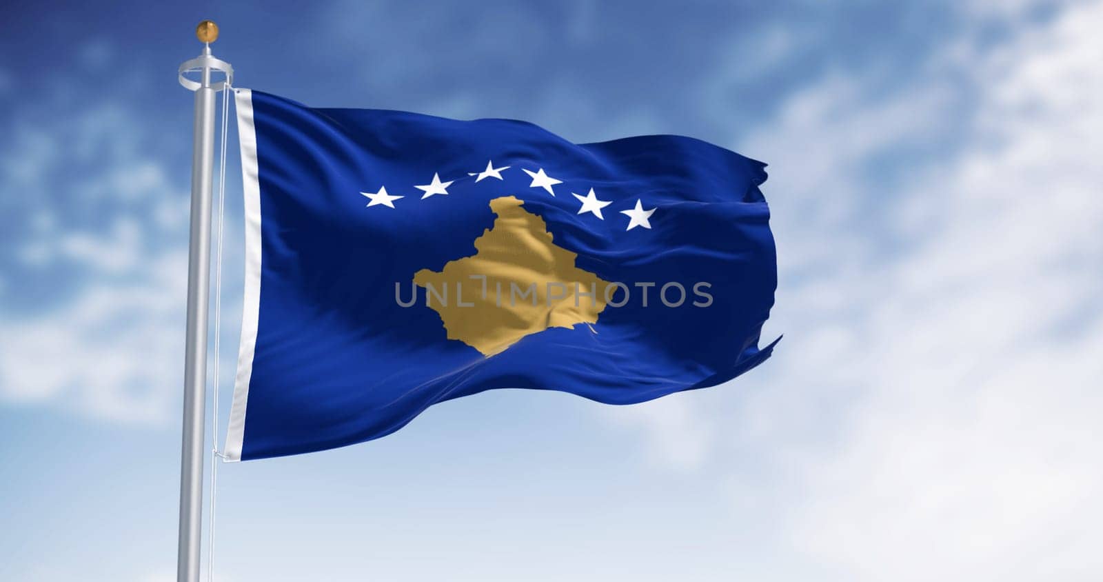 Kosovo national flag waving on a clear day. Six white stars above a golden map of Kosovo in a blue field. 3d illustration render. Rippling textured fabric.