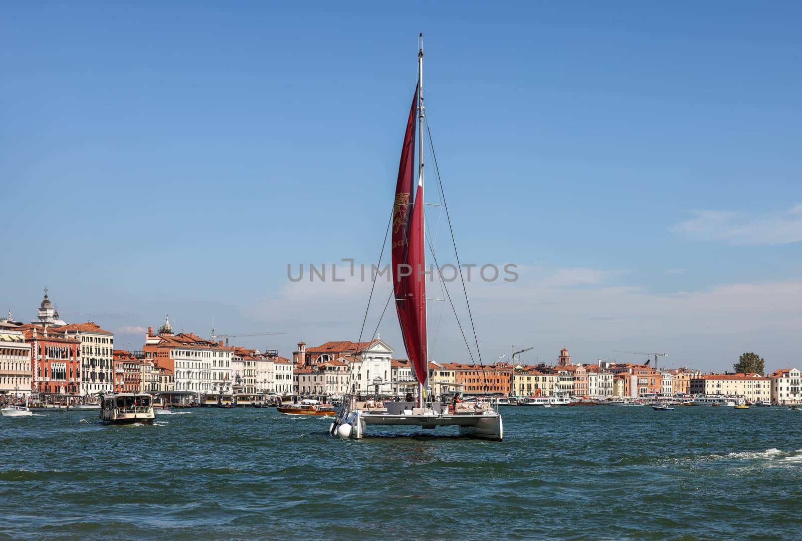 Venice, Italy - September 5, 2022: Catamaran sailing along the San Marco Canal in Venice, Italy