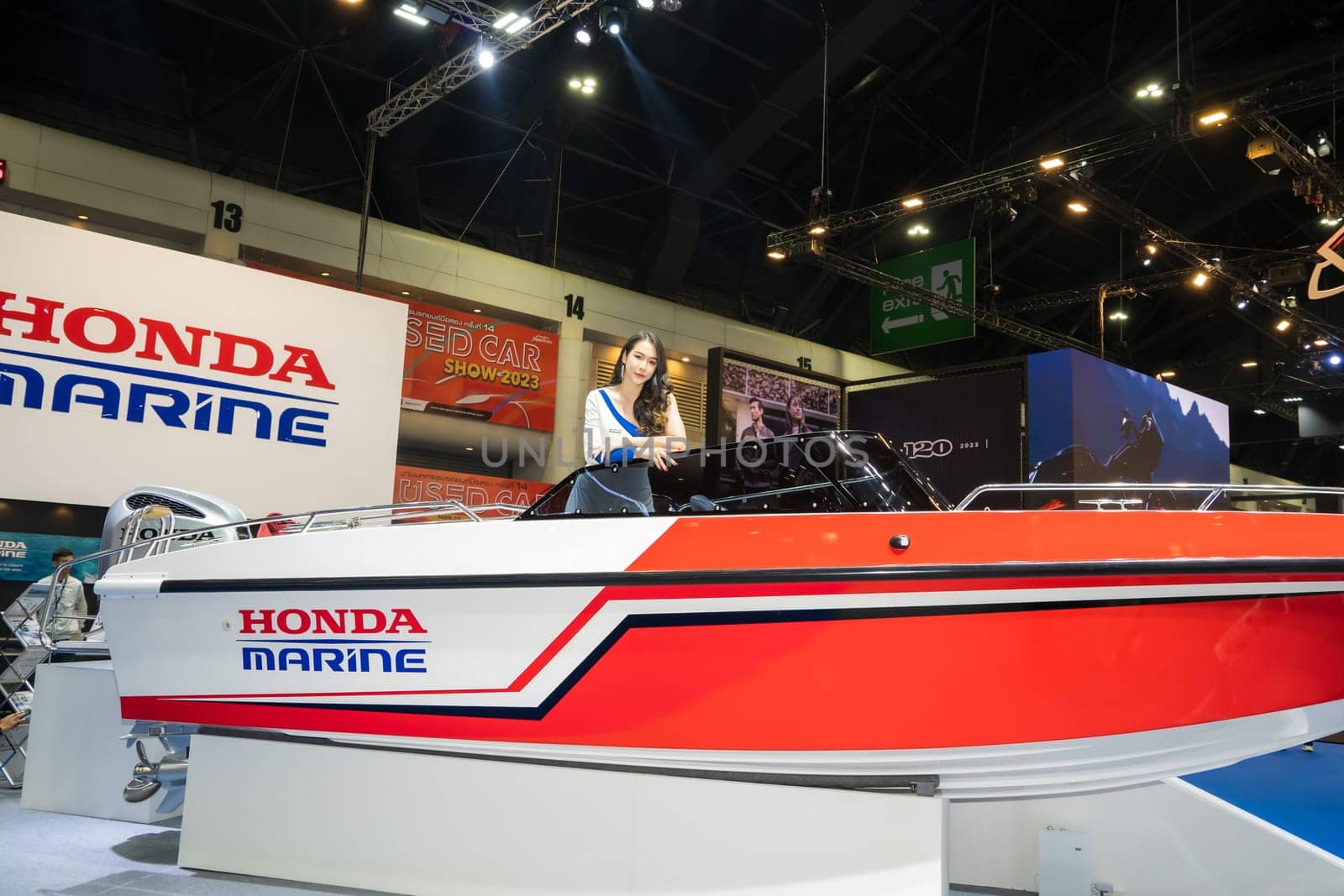 Nonthaburi, Thailand - APR 2, 2023 Unidentified model poses with a boat at The 44th Bangkok international motor show 2023 at IMPACT Arena, Muang Thong Thani, Nonthaburi, Thailand.