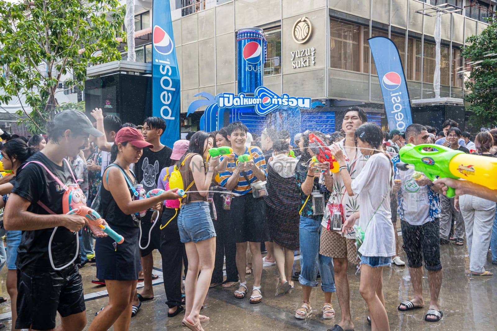 Siam Square, Bangkok, Thailand - APR 13, 2023 Songkran Festival, The short action of people joins celebrations of the Thai New Year or Songkran in Siam Square Bangkok, Thailand.