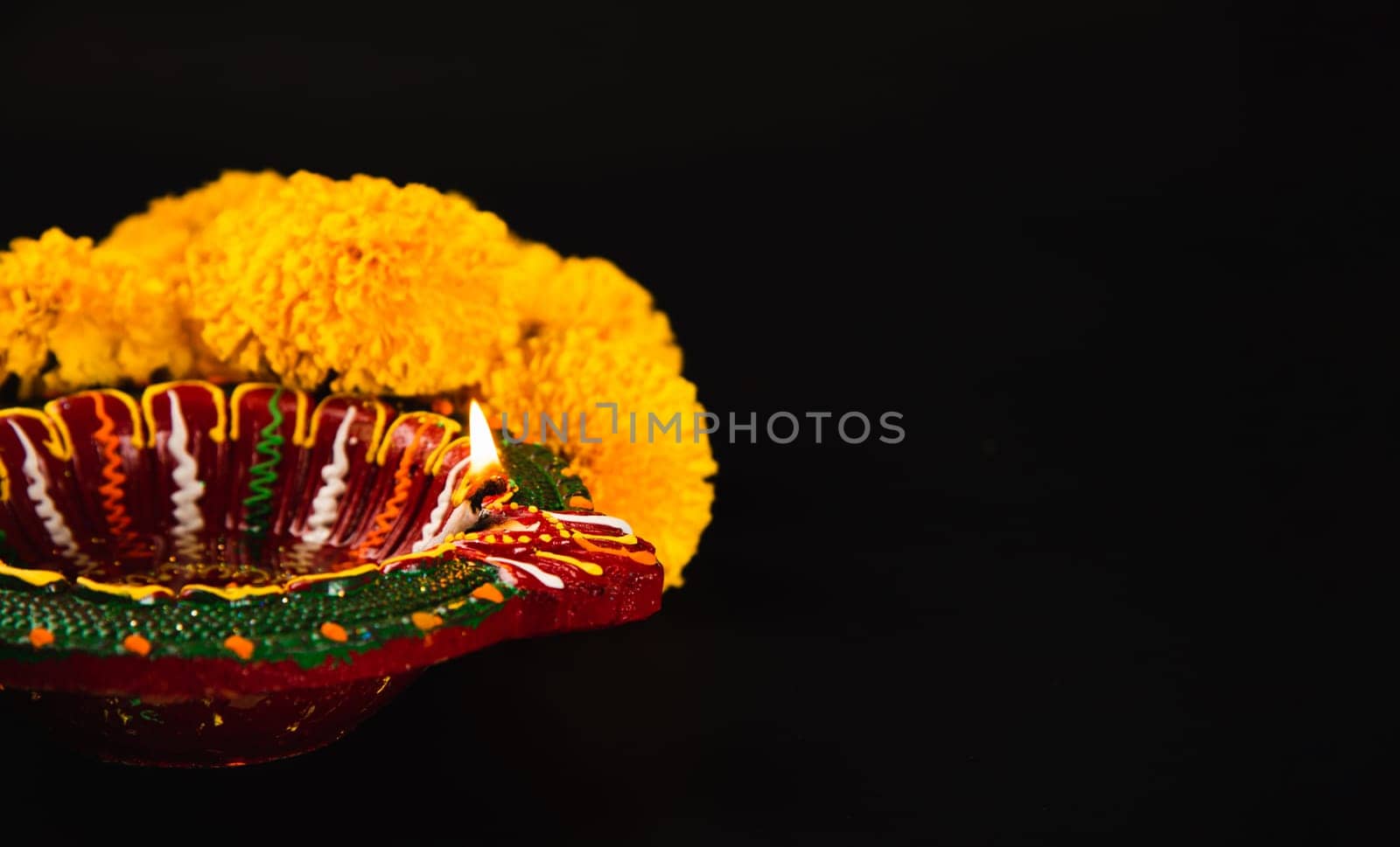 Elegance in Diwali, A stunning Diwali lamp and ornate flower rangoli set against a striking black backdrop. Perfect for Diwali, wedding invitations, and cultural celebrations.