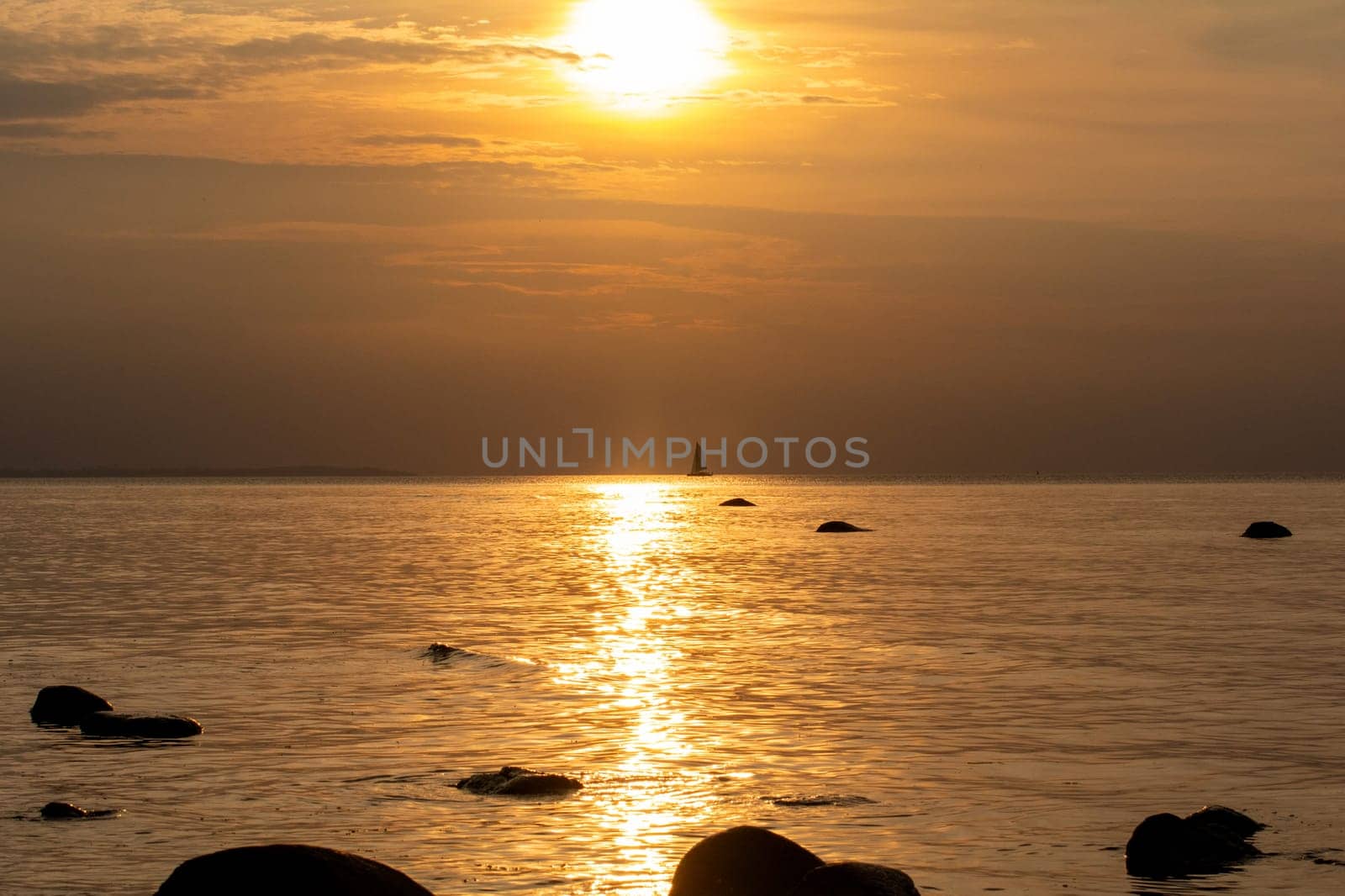 Beautiful orange sunset over the sea, a ship on the horizon