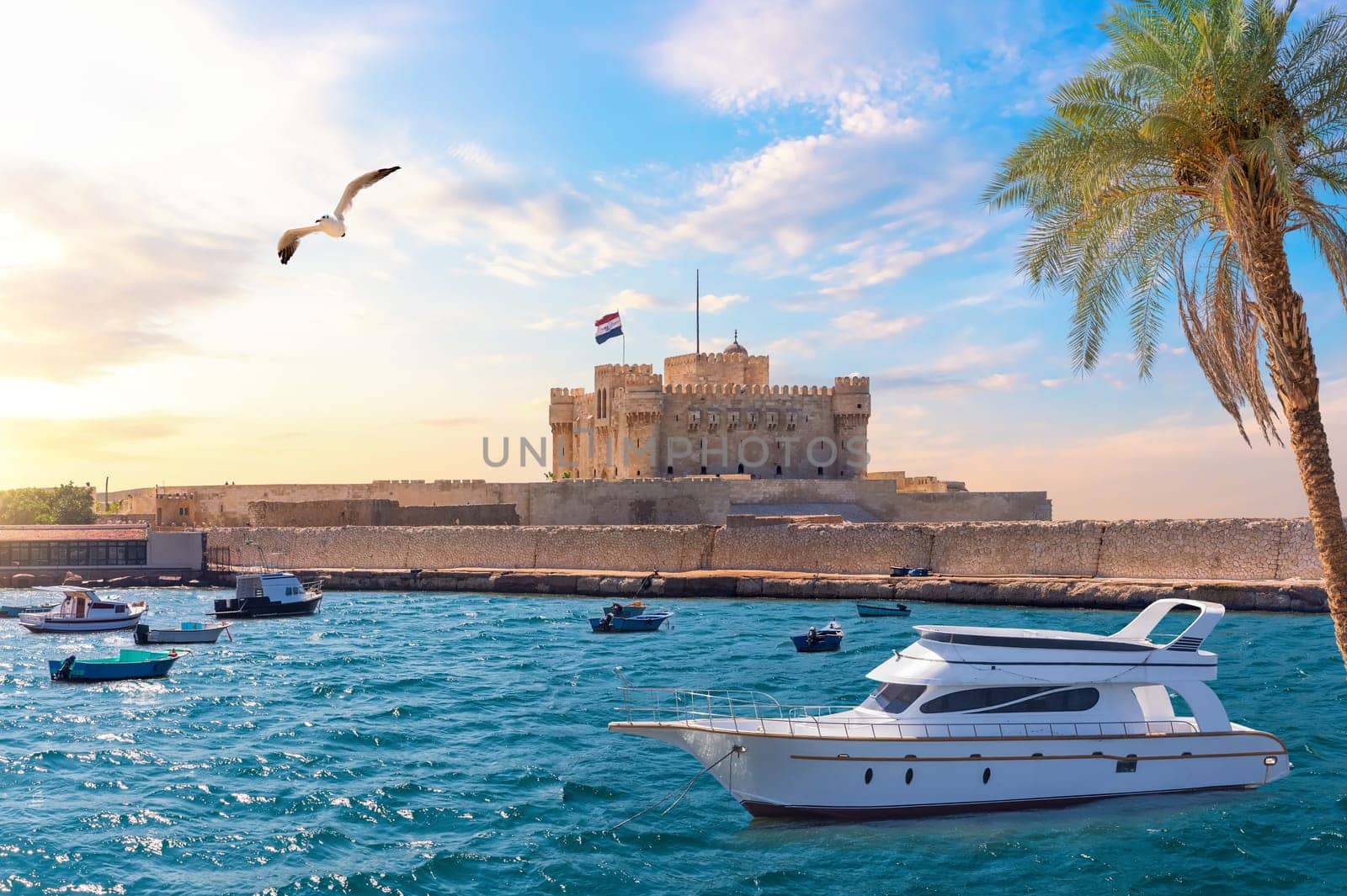 Boat in the Mediterranean in front of Citadel of Qaitbay, Alexandria, Egypt.