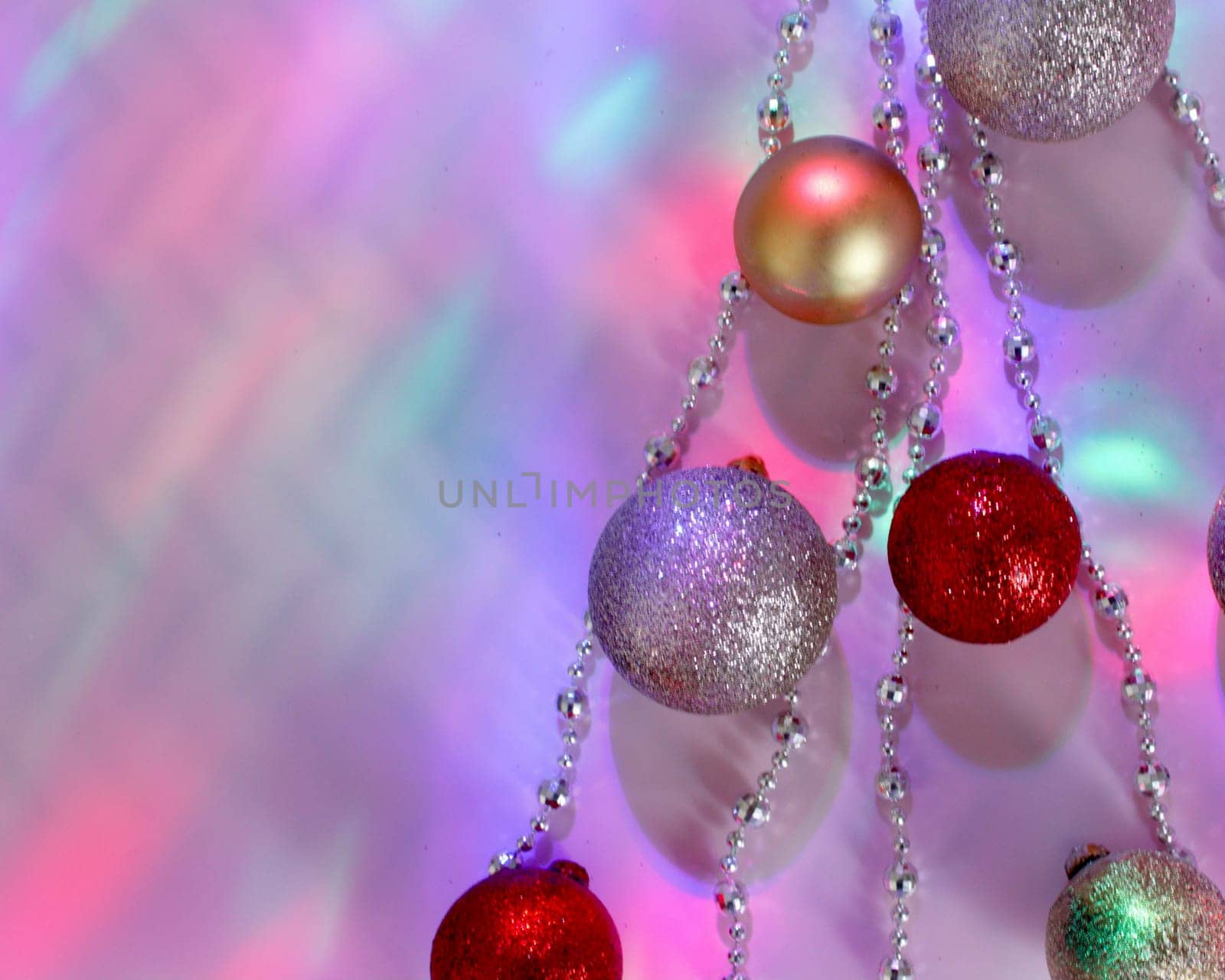 christmas balls on a background of colored lights and bokeh.