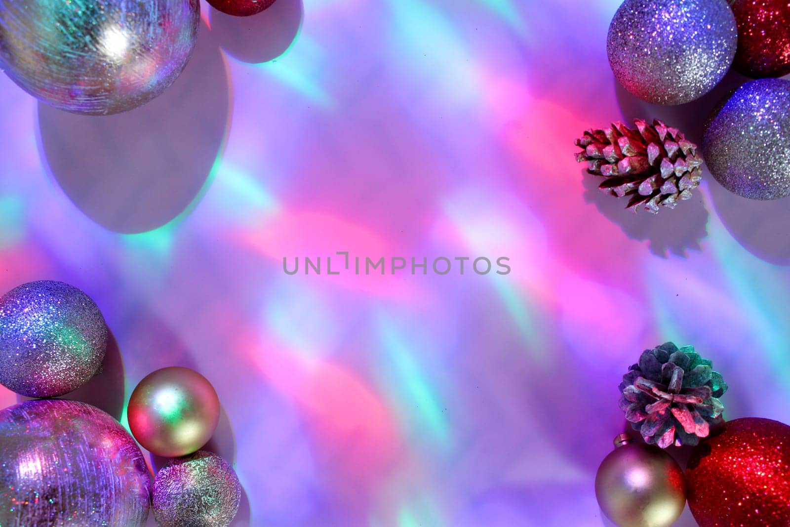 christmas balls on a background of colored lights and bokeh.