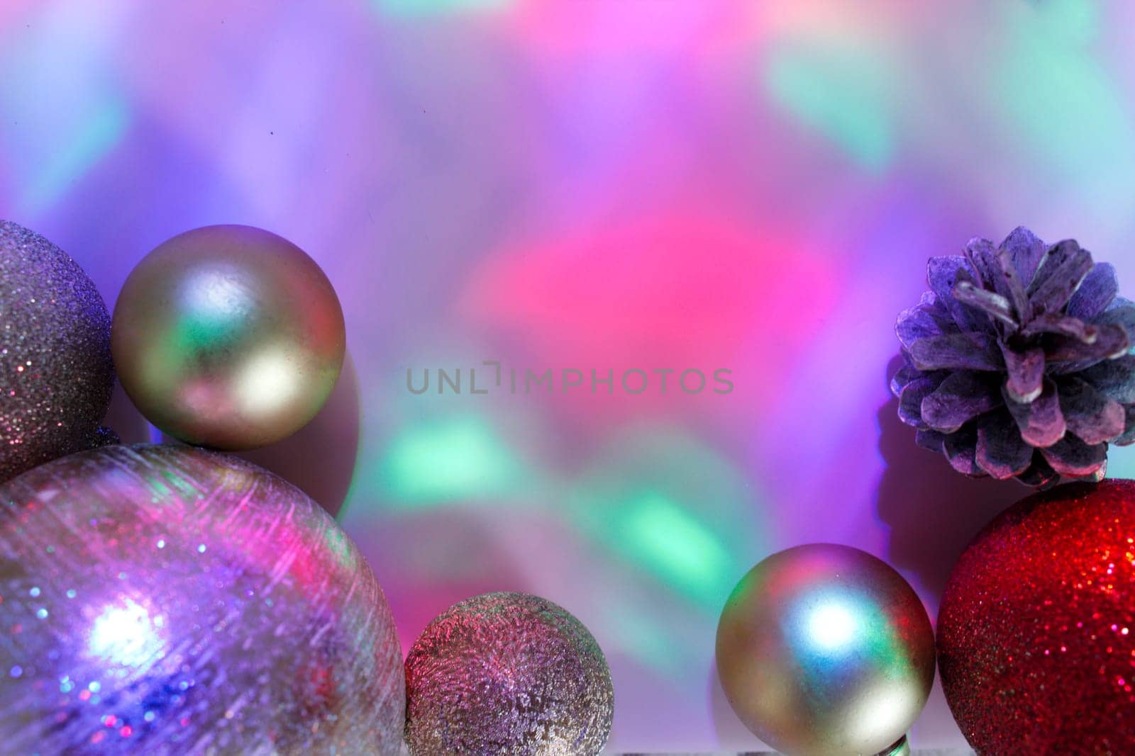 christmas balls on a background of colored lights and bokeh.
