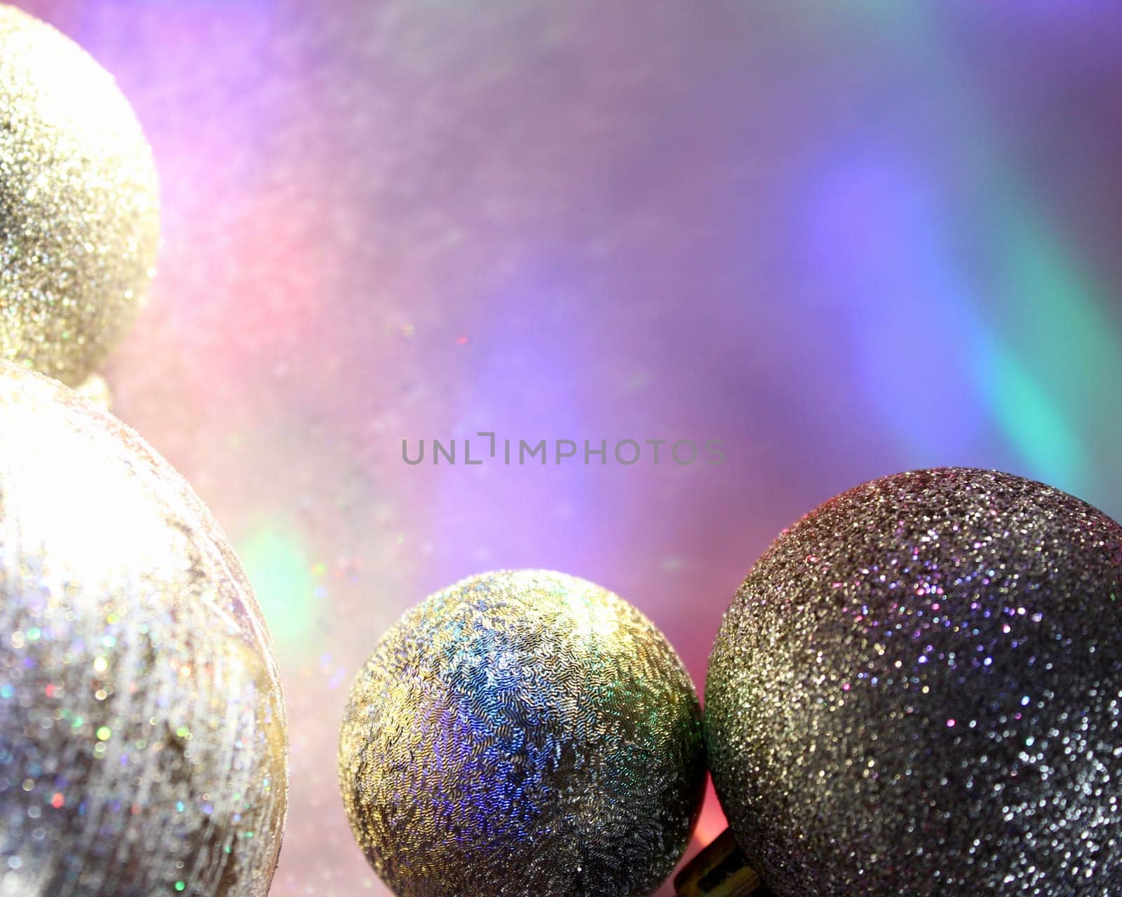 christmas balls on a background of colored lights and bokeh.