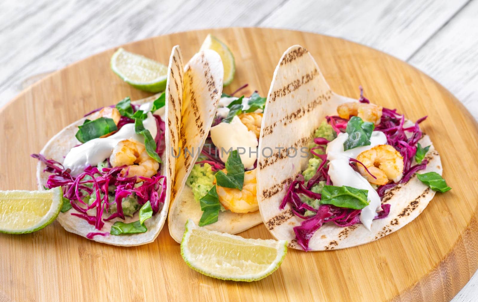 Tacos with shrimp, red cabbage, guacamole and sour cream