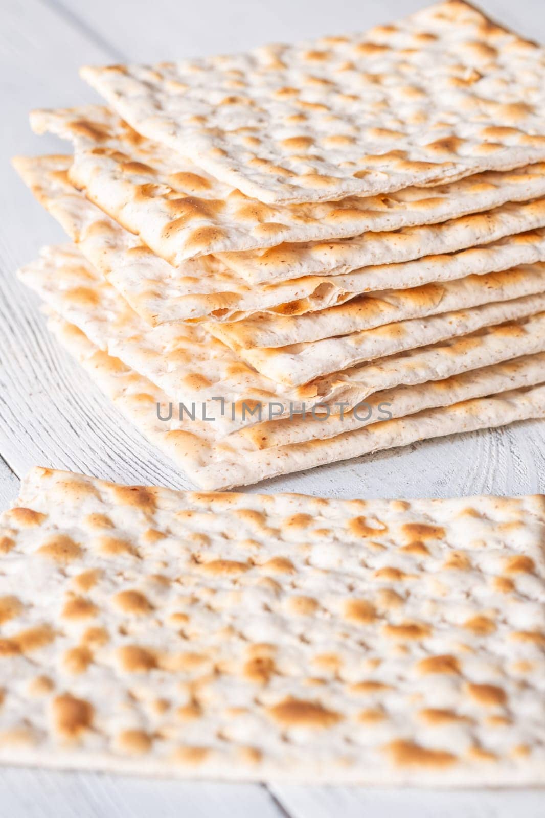 Stack of Matzah on the white wooden background