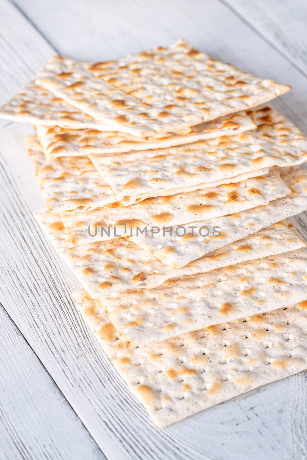 Stack of Matzah on the white wooden background