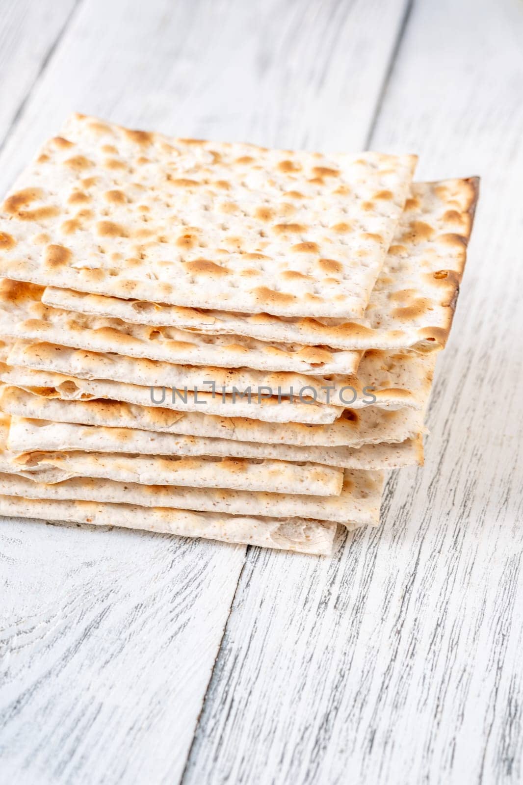 Stack of Matzah on the white wooden background