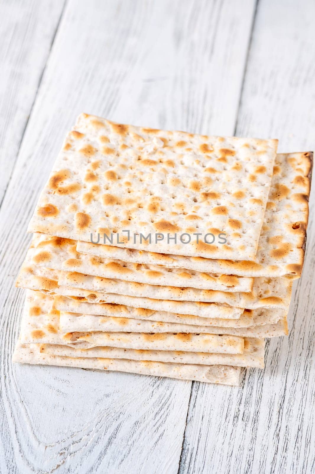 Stack of Matzah on the white wooden background