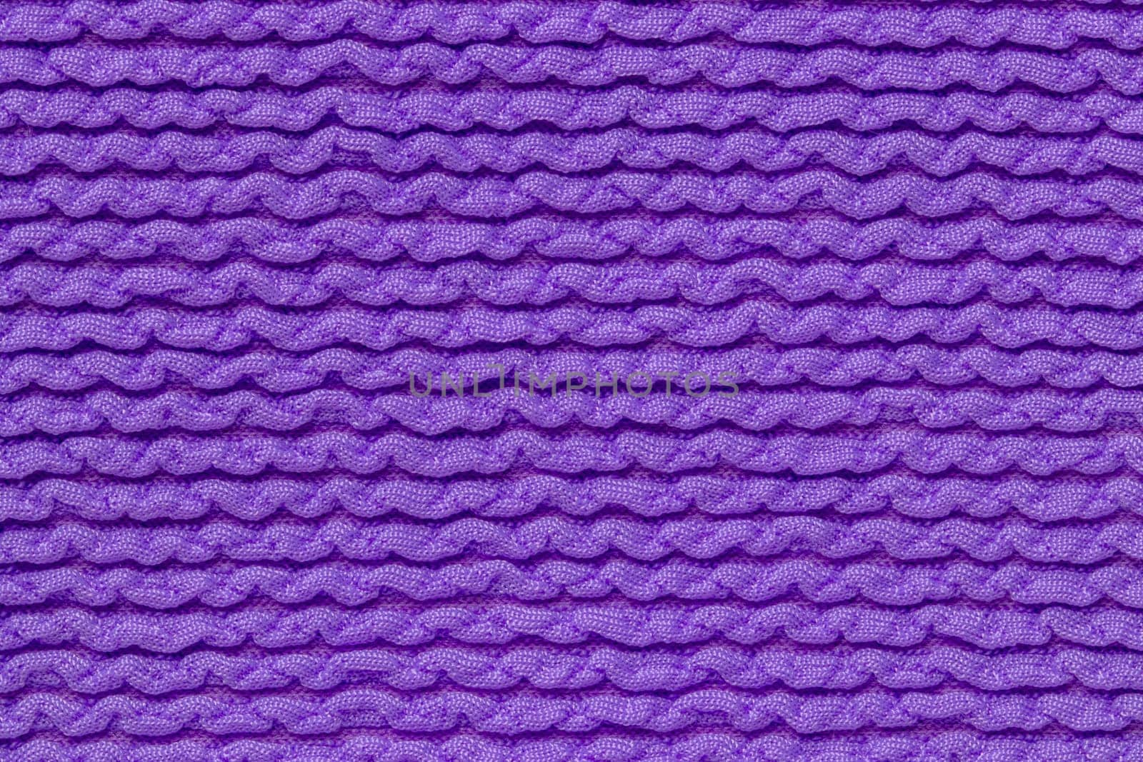 Pink fabric texture. Close-up of an elastic blue nylon fabric with seamless pattern for sports equipment, backpacks, bags or other garments. Macro.