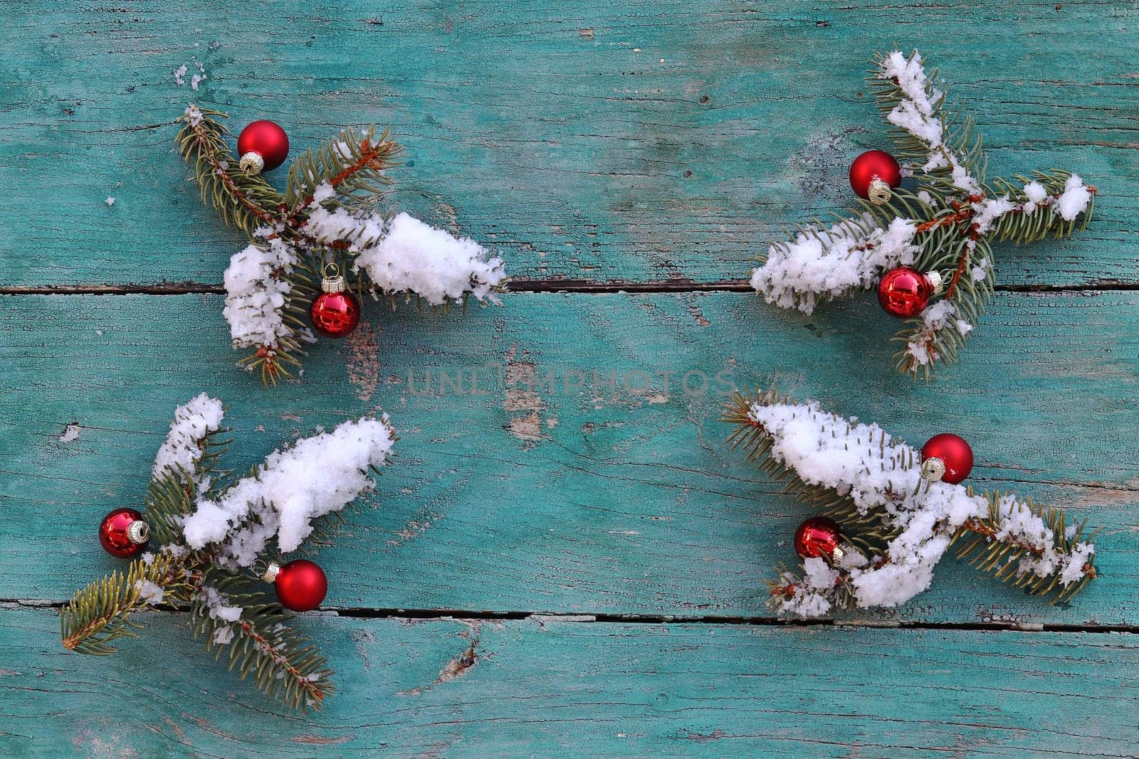 Christmas background Fir branches with Christmas tree baubles and snow on wood