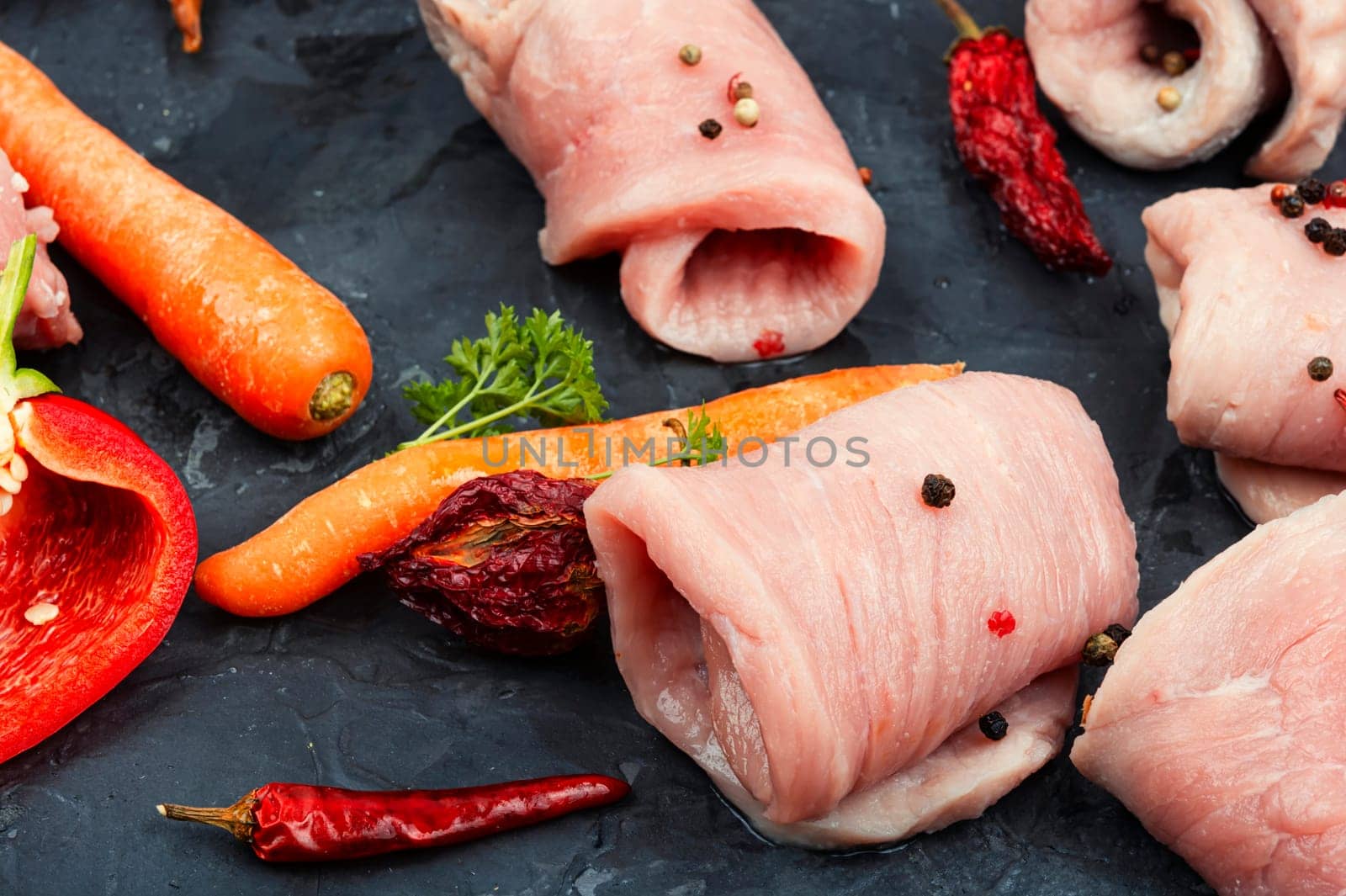 Fresh, uncooked pork meat rolls. Raw meat. Roll ready for baking.