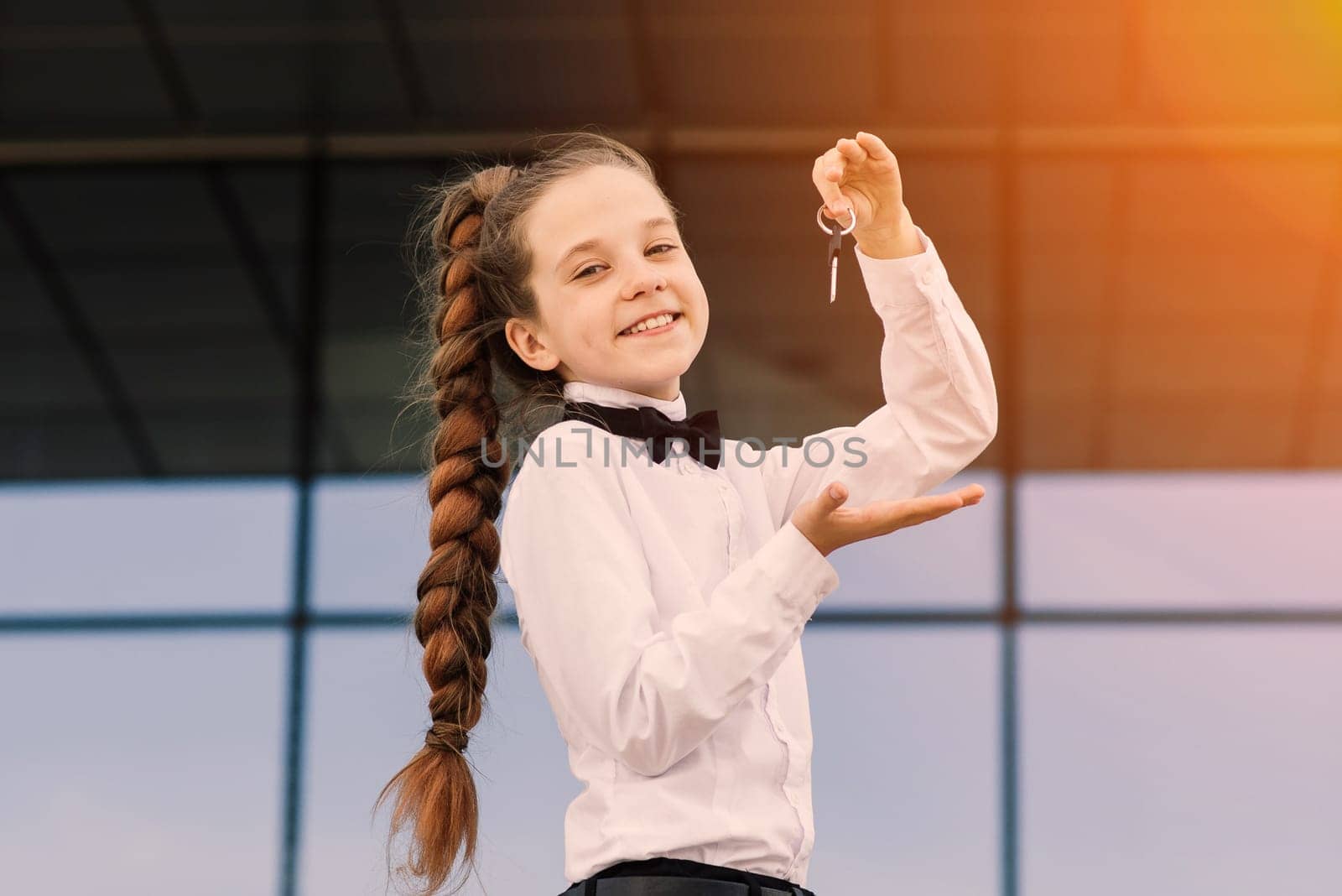 Beautiful caucasian girl holding car keys, apartment. World international car free day.