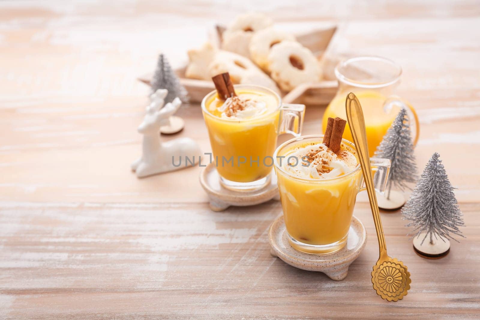 Homemade eggnog, egg liqueur for Christmas with small cookies