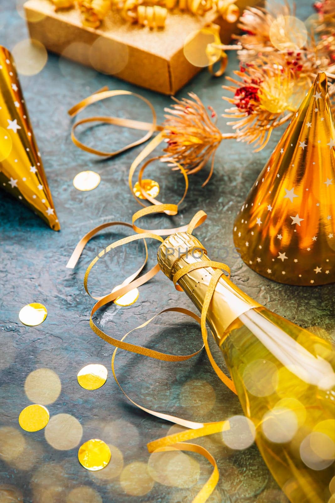 Happy New Year celebration,  bottle of champagne, bright lights and gifts
