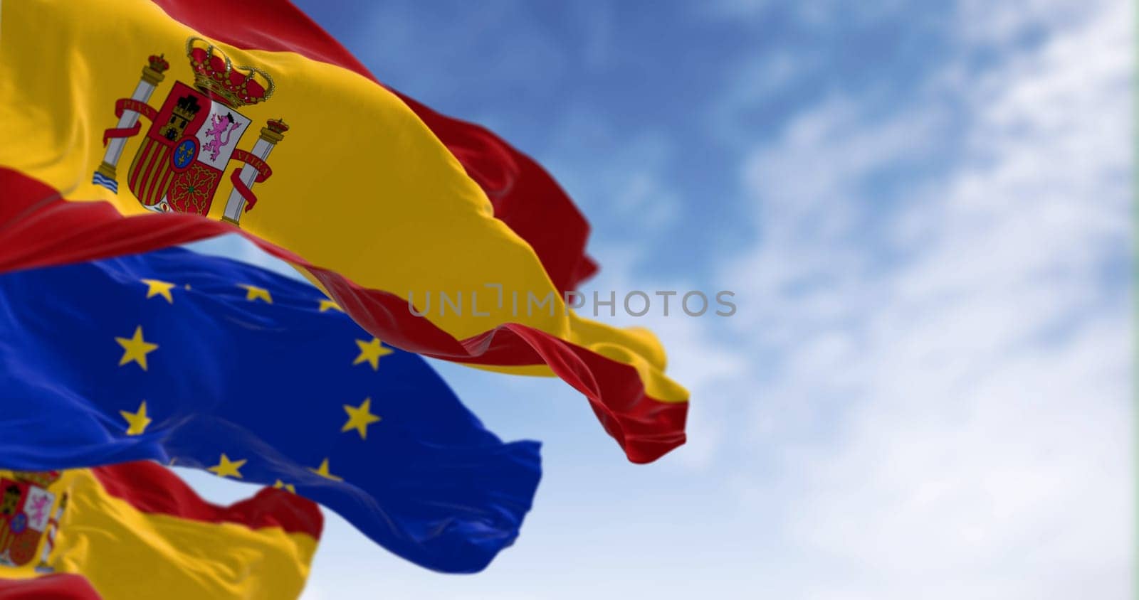National flags of Spain waving with the European Union flag on a clear day. International cooperation. 3d illustration render. Rippled fabric. Selective focus
