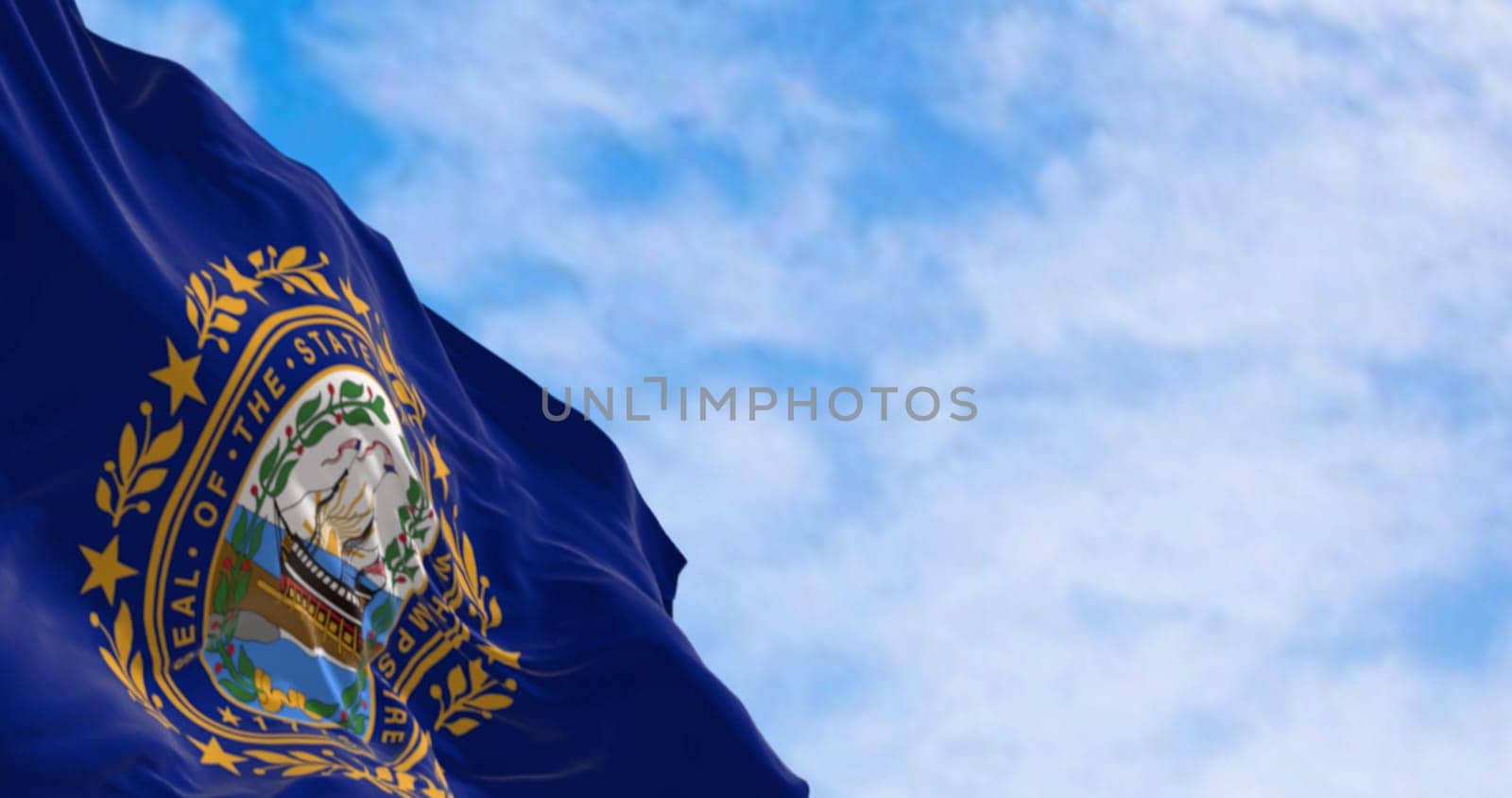 Close-up of New Hampshire state flag waving in the wind. Dark blue background with a state seal in the middle. 3d illustration render. Selective focus. Rippling fabric