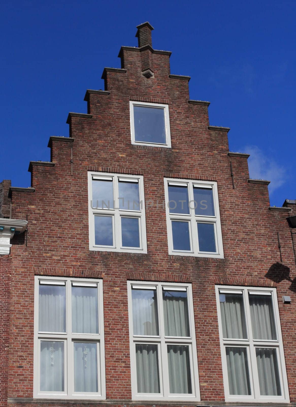Beautiful old house with stepped gables, built of red brick stones