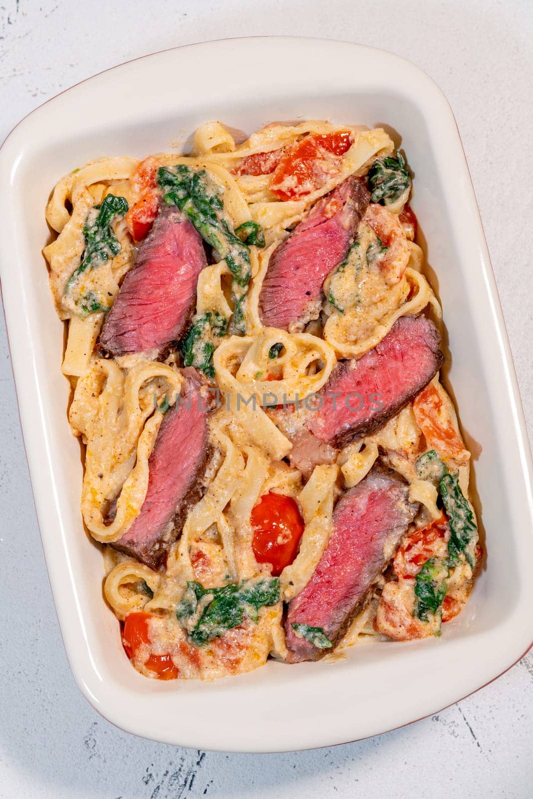 Creamy steak fettuccine pasta with spinach and tomatoes