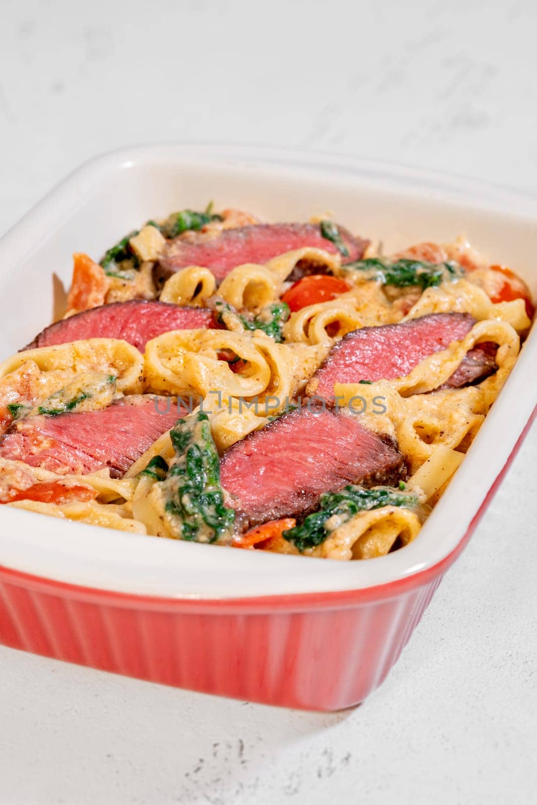 Creamy steak fettuccine pasta with spinach and tomatoes