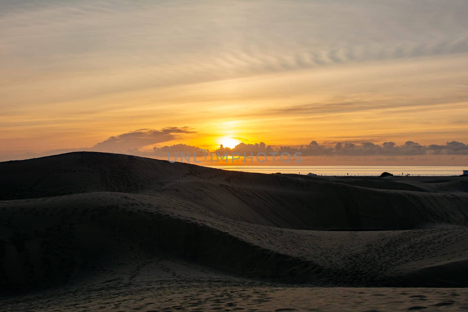 In the dunes of Maspalomas at sunrise on Gran Canaria in Spain. The huge sand dunes resemble a small desert and are a nature reserve.