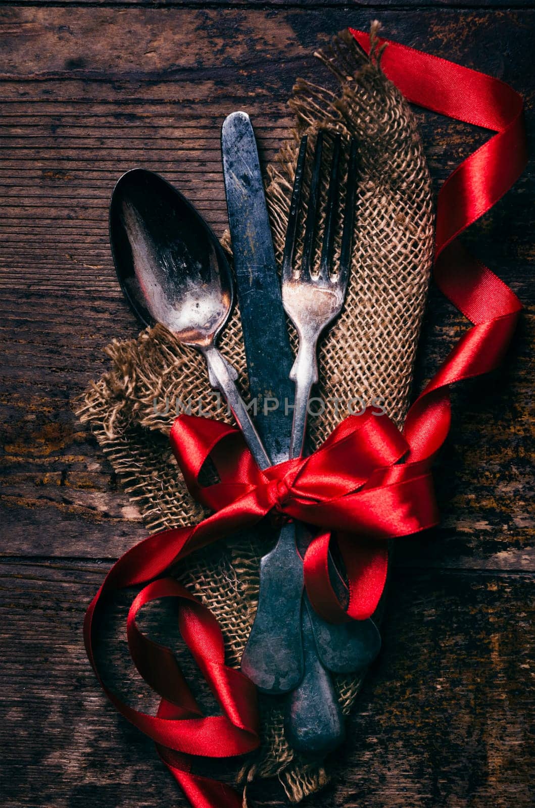 Valentines dinner background with vintage silverware and red ribbon on wooden table. Luxury restaurant menu for romantic celebration event. Valentine day dine.