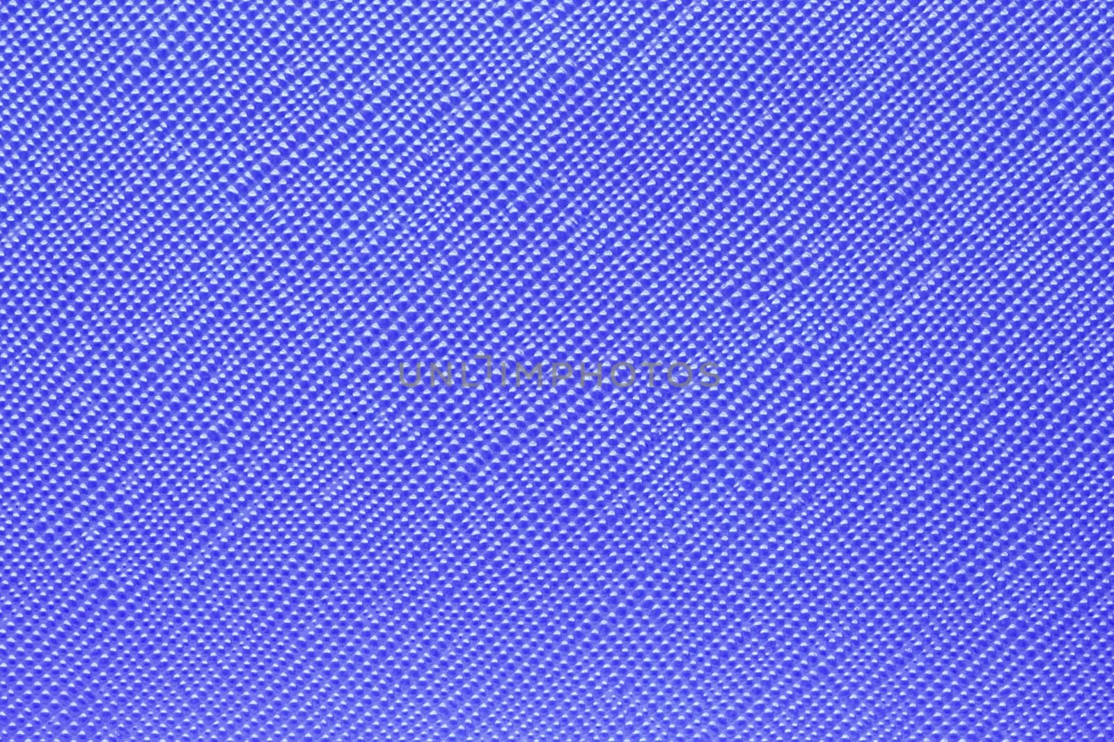 Seamless plastic texture background. Close-up of a detail from a blue surface of a cosmetic bag. Beautiful backdrop. Macro.