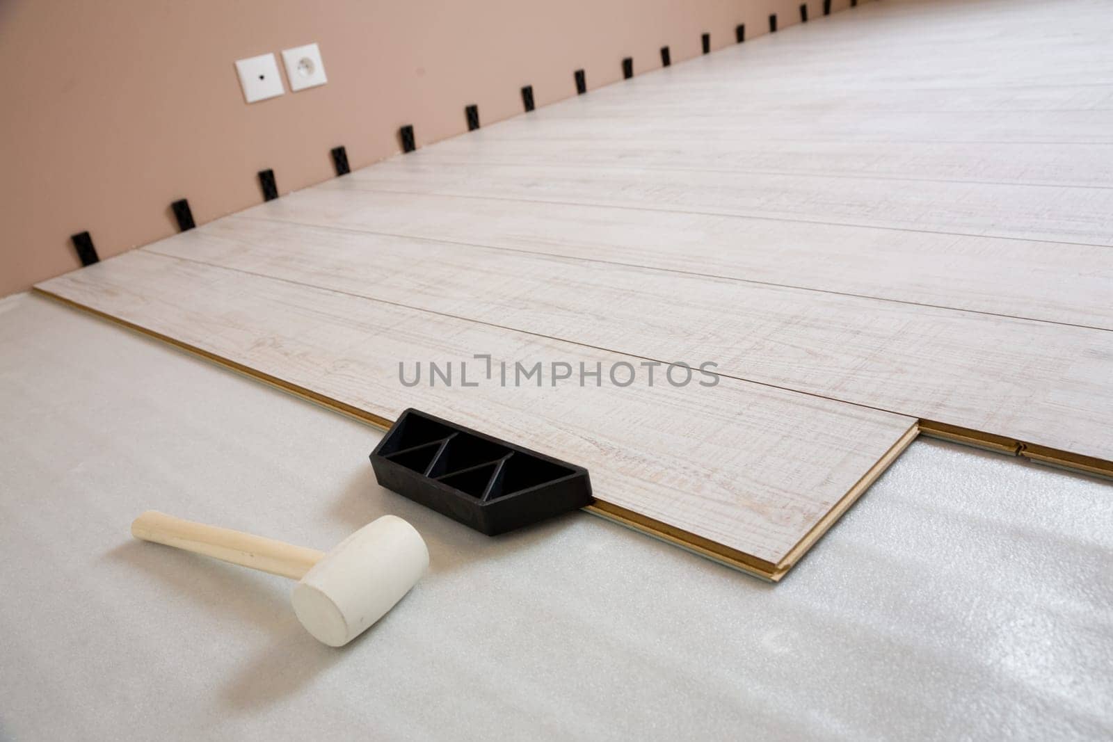 Installing new laminate wood flooring in the house and tools