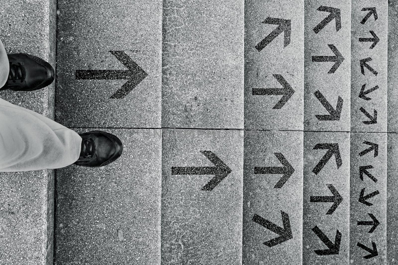 A woman stands on a staircase and has to decide which way she wants to go