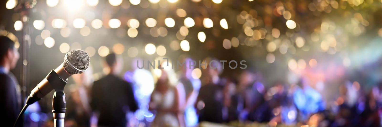 microphone on stage with blurred people and lights in background. AI generated