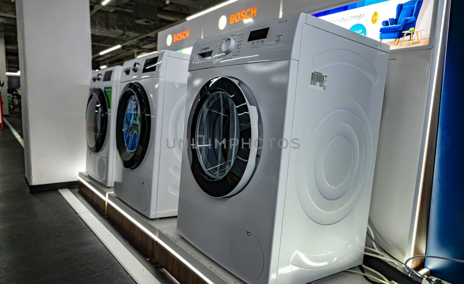 POZNAN, POL - DEC 8, 2023: Front-loader washing machines by Bosh put up for sale in a household goods store