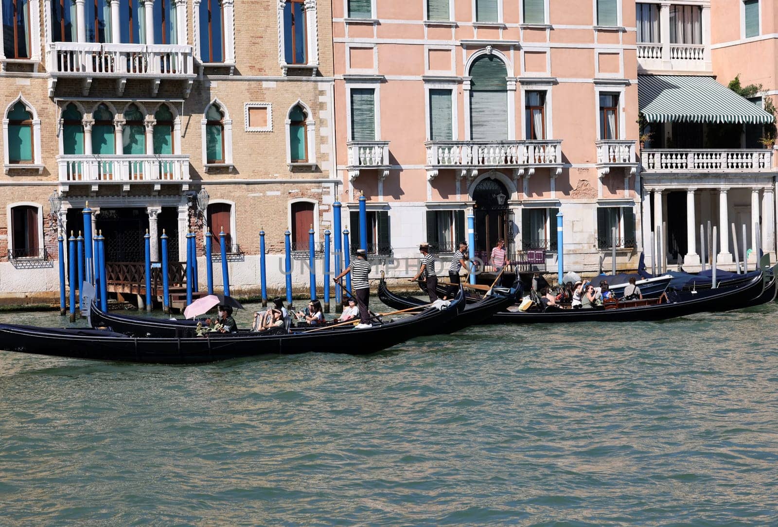 Venice, Italy - September 5, 2022: Tourists during a Gondola cruise on the Grand Canal in Venice. Italy