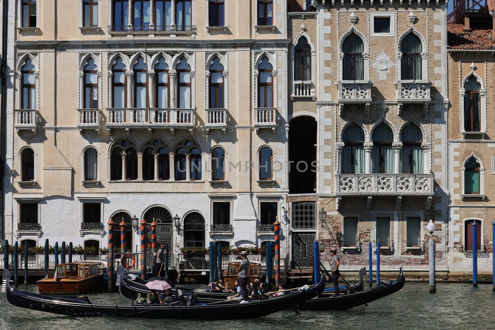 Venice, Italy - September 5, 2022: Tourists during a Gondola cruise on the Grand Canal in Venice. Italy