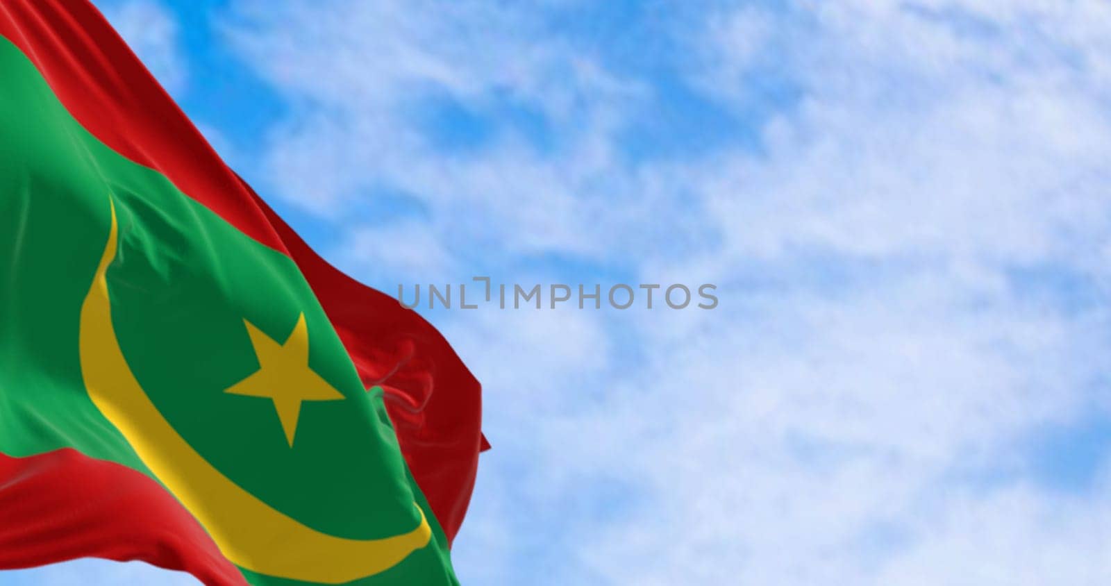 Close-up of the Mauritania national flag waving in the wind. Green with yellow crescent, star between two red bands. 3d illustration render. Selective focus. Close-up