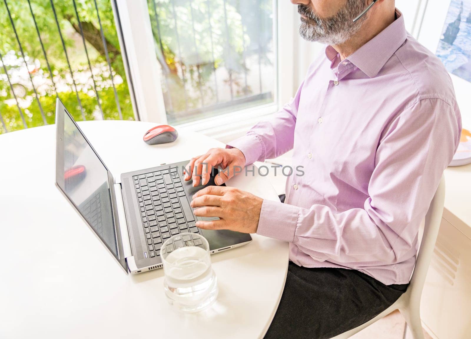 Man working with notebook and smartphone. Smart working.