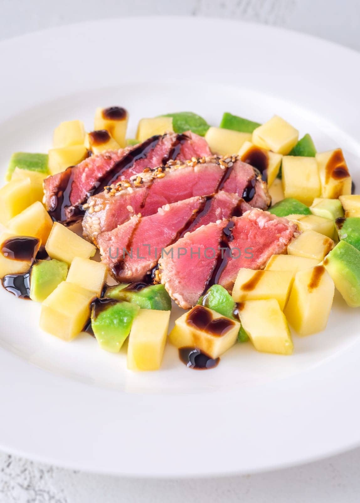 Portio of tuna with mango and avocado