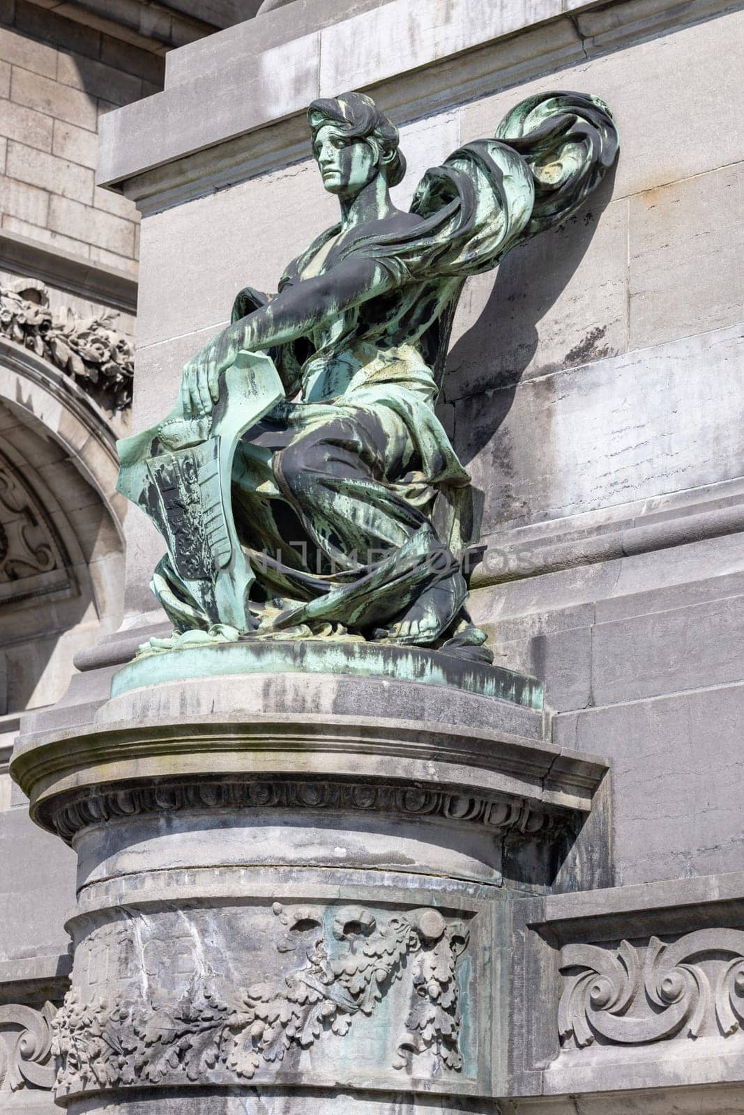 Brussels, Belgium - May 16, 2023: One of the sculptures on the base of triumphal arch Cinquantenaire Arch in Cinquantenaire Park