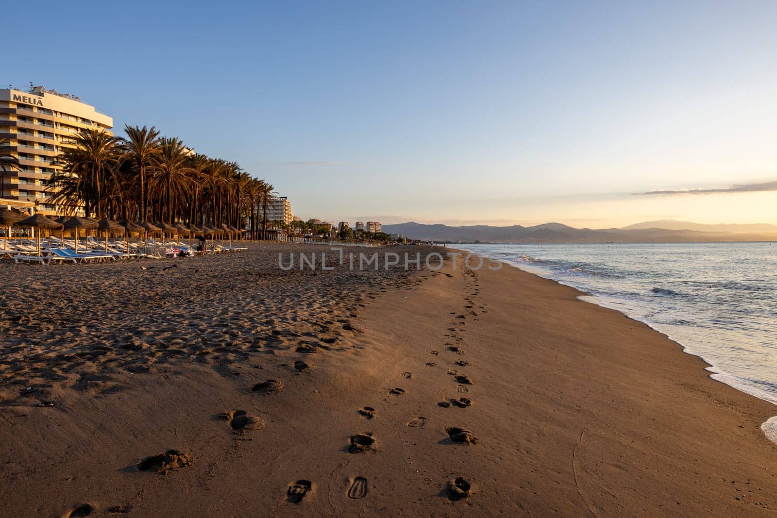 Torremolinos, Spain - September 12, 2023: View of Bajondillo Beach and hotels in Torremolinos at sunrise. Costa del Sol, Spain.