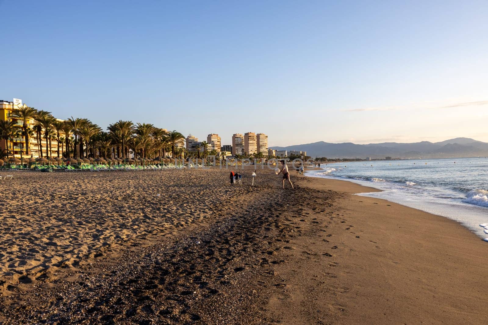 Torremolinos, Spain - September 12, 2023: View of Bajondillo Beach and hotels in Torremolinos at sunrise. Costa del Sol, Spain.